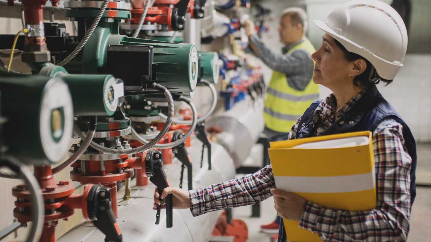 Engineer checking pump on steam system