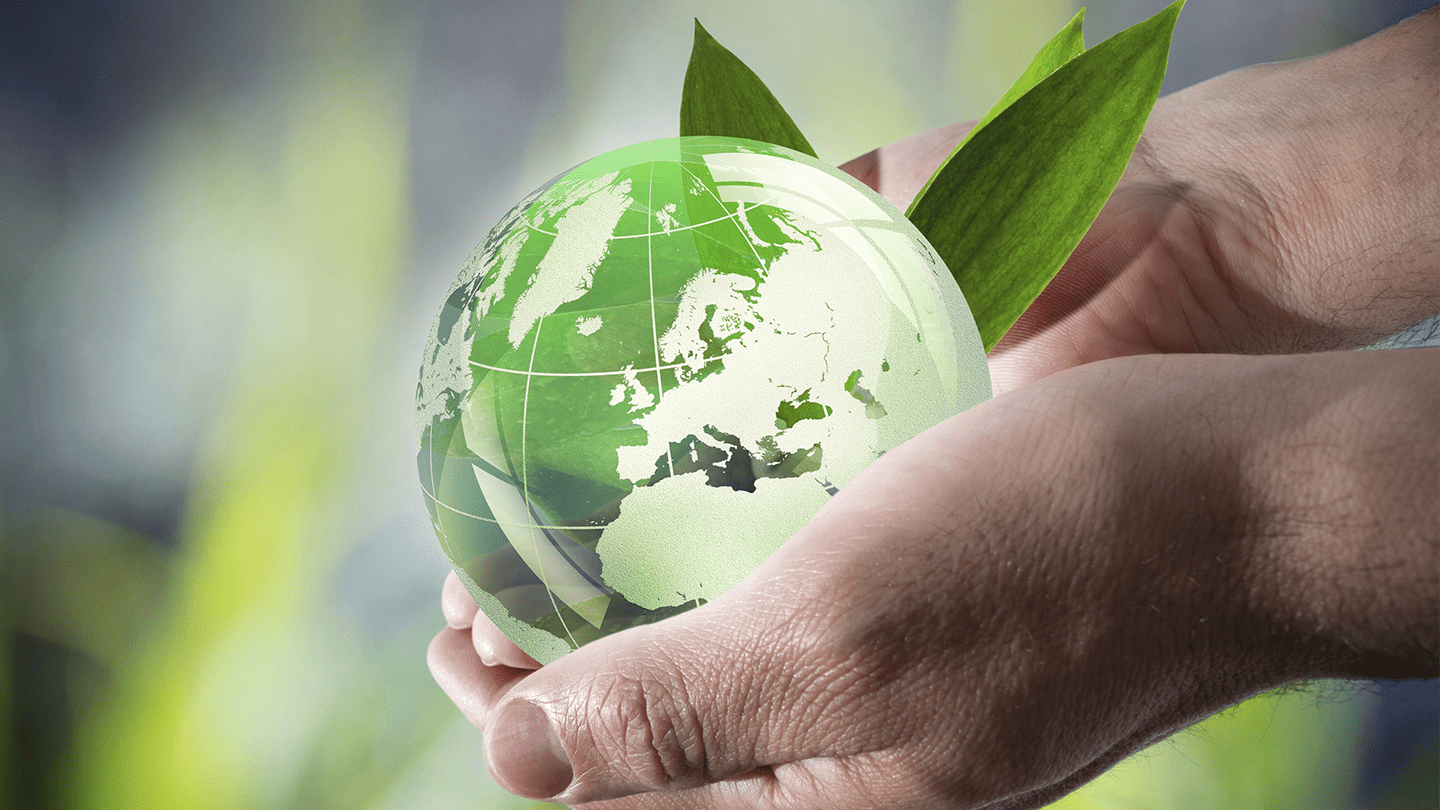 Hand holding a green planet