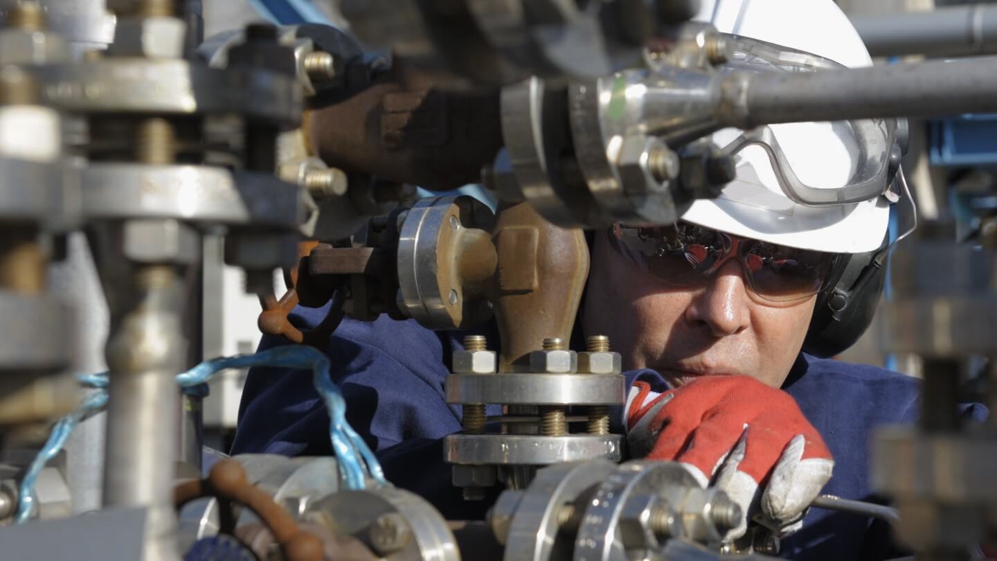 Engineer inspecting refinery equipment